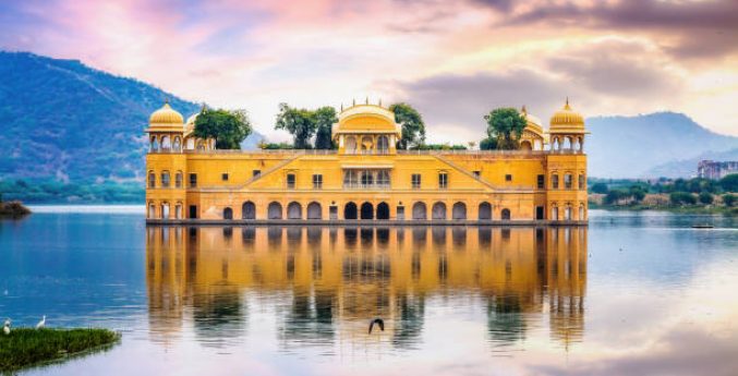 Jal Mahal water palace Jaipur Rajasthan at sunset with vibrant moody sky